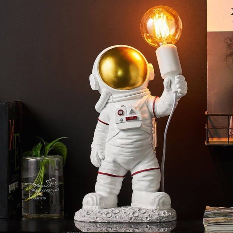 Dekorativ astronautfigur med vintage glödlampa, idealisk för tematisk rymd- eller vetenskaplig inredning.