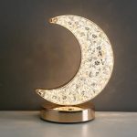 Månlampa i kristall, elegant och raffinerad, står på en bas av gyllene metall, idealisk för vetenskaplig eller modern inredning.