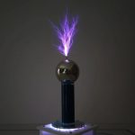 Tesla-boll i glas med lila elektrisk urladdning, som illustrerar ett fascinerande vetenskapligt fenomen.