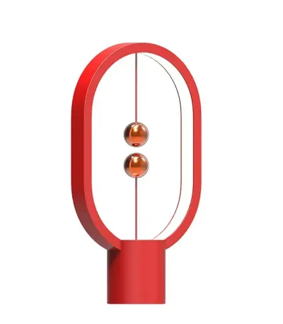 Newton lampa i röd glas med oval metallram, modern och vetenskaplig design, perfekt för kontors- eller vardagsrumsdekoration.