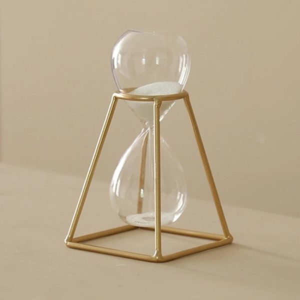 Tidsbärare i glas med gyllene ram, elegant och modern vetenskaplig dekoration, idealisk för älskare av industriell design och vetenskapsinspirerade dekorationsobjekt.