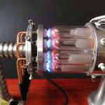 Vetenskaplig apparat med glasrör och metallkomponenter, använd för laboratorieexperiment.