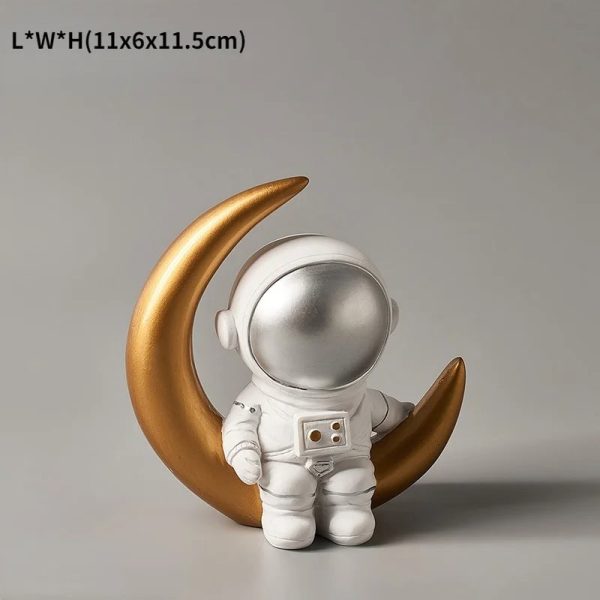 Söt astronautfigur med en gyllene halvmåne, idealisk för vetenskaplig och lekfull dekoration. Perfekt för astronomi- och originaldesignentusiaster.