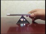 Magnetisk pyramid som stöder en smartphone, vilket skapar en fascinerande visuell effekt med ljus och reflektion. Idealisk för vetenskaplig dekoration eller optiska experiment.