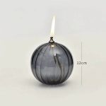 Globusljus i svart glas med tänd låga, originell vetenskaplig dekoration.