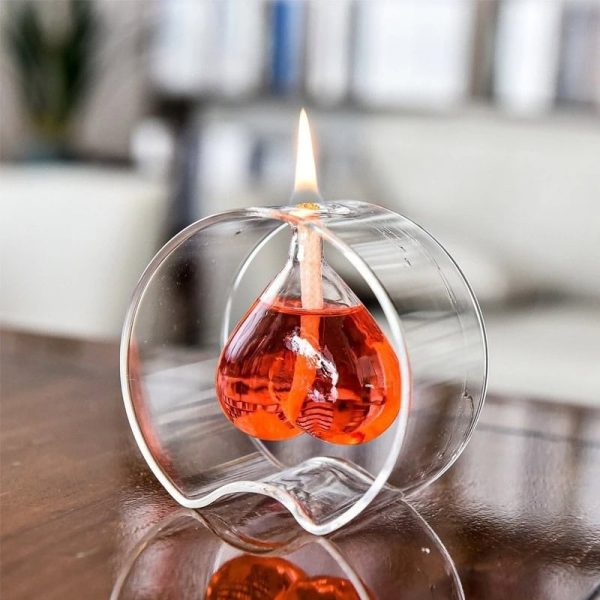 Dekorativ ljushållare i form av ett laboratoriebalon i transparent glas med röd vätska och tänd låga, perfekt för vetenskaplig eller tematisk dekoration.