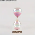 En färgglad timer i glas med rosa sand, som illustrerar en flödestid på 30 minuter.