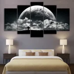 Konstpanel som föreställer månen och moln, perfekt för modern och kosmisk dekoration i ett sovrum.