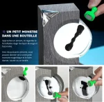 Mini magnetmonster i en flaska, hanteras med ett litet grönt verktyg, för en lekfull och fascinerande vetenskaplig upplevelse.