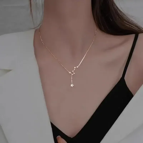 Delikat halsband med vetenskapligt hängsmycke i guld, buren av en kvinna, perfekt för vetenskaps- och sofistikerade smyckenälskare.
