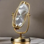 Dekorativt timglas i guldmässing med glas i form av en glödlampa, idealiskt för vetenskaplig eller vintage dekoration.