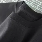 Svart t-shirt i ekologisk bomull, enkel och elegant, perfekt för en avslappnad eller casual stil, tillverkad av hållbara material för optimal komfort.