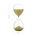 Vetenskapligt timglas i glas med beige sand, perfekt för dekoration eller experiment. Mått: 20,5 cm hög, 8 cm i diameter.
