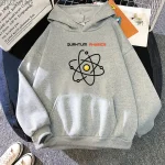 Grå hoodie med atomdesign och texten "Quantum Physics" för vetenskaps- och kvantfysikentusiaster.