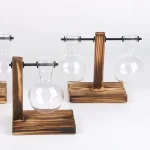 Set med träställningar med upphängda glasflaskor, idealiska för vetenskaplig eller laboratoriedekoration, som förenar estetik och funktionalitet.