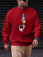 Röd sweatshirt med mönster av planeter och astronauter, urban och trendig stil, perfekt för vetenskaps- och astronomientusiaster.